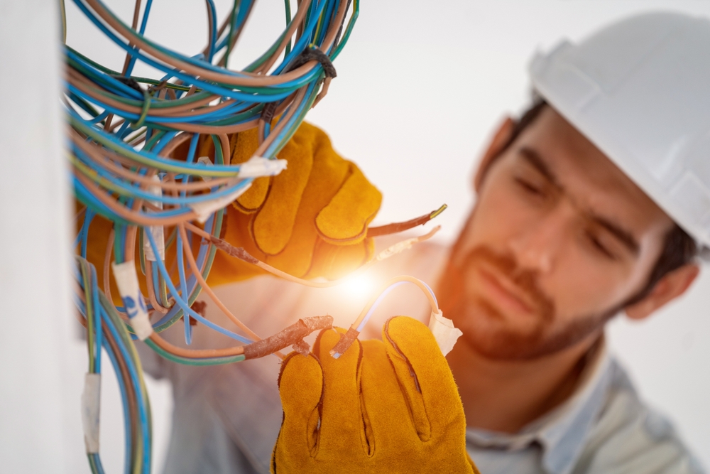 Electrician,Working,With,Cable,On,The,Construction,Site,house,And,House